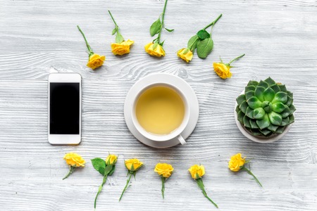 spring flatlay on light wooden work desk background top viewの写真素材