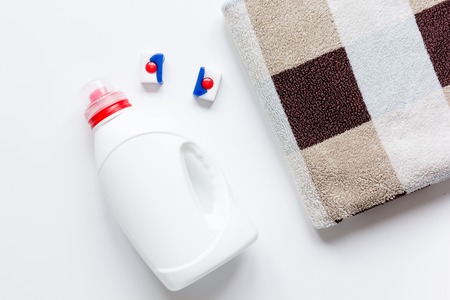 Pile of pastel towels with detergent white background top viewの写真素材