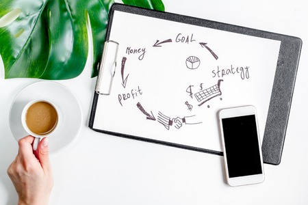business plan development with mobile on desk background top view mock-upの写真素材