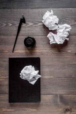 writer workplace with tools on wooden background top view mockupの写真素材