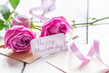 Mothers day gift with peony flowers, envelope and greeting cardの写真素材