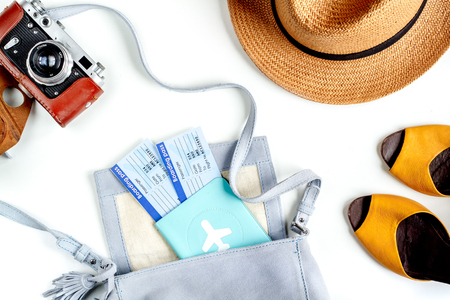 vacation concept with traveller outfit passport, tickets and camera on white desk background top viewの写真素材