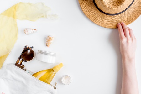 cream and lotion cosmetic for sun protection with hat in a sunbath concept on white background top...