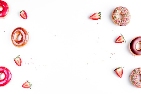 lunch with donuts and strawberry on white background top view mock upの写真素材
