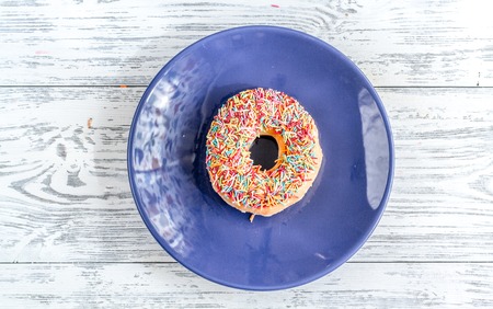 coloful donut on plate flat lay wooden background top view mock upの写真素材