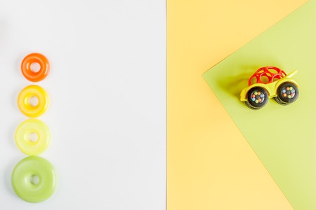 kids desk design with toys on yellow white background top view space for textの写真素材