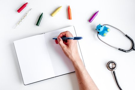 children's doctor work with stethoscope and markers on white desk background top view mock-upの写真素材