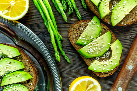 homemade sandwiches with avocado and bread on wooden kitchen table background top viewの写真素材