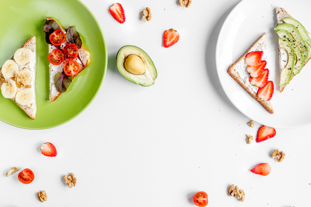 healthy breakfast with sandwiches set on plate on white table background top view mockupの写真素材