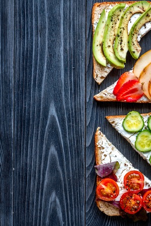 Healthy breakfast with sandwiches set on dark wooden background top view mockupの写真素材