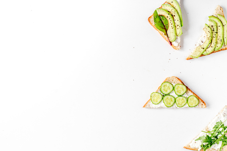 Lunch with triangle sandwiches on white table background top view mockupの写真素材