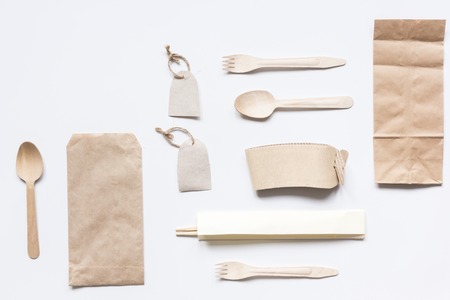 food delivery workdesk with paper bags and flatware table background top view mock-upの写真素材
