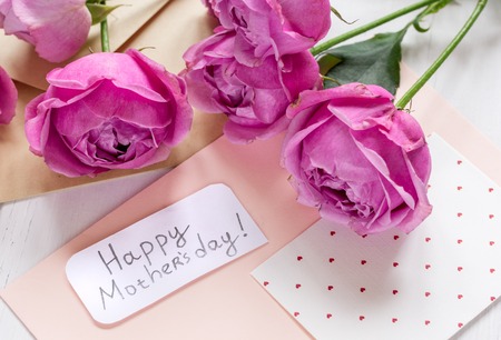 Mothers day gift with peony flowers, envelope and greeting cardの写真素材