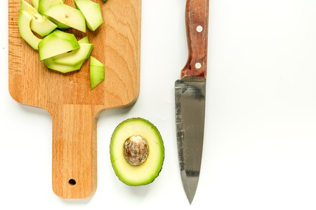 sliced avocado for homemade sandwiches on kitchen table top view space for textの写真素材