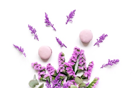 Trendy woman pattern with flowers and macaroons on plate top viewの写真素材