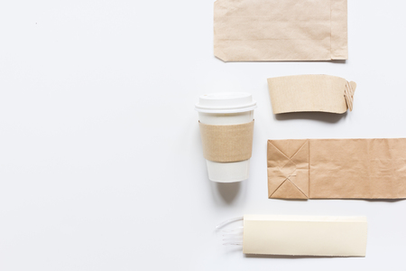 food delivery workdesk with paper bags and plastic cup on restourant white table background top view mock-upの写真素材