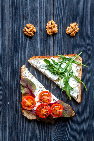 triangle sandwiches set on dark wooden table background top viewの写真素材