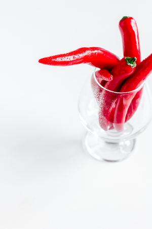 red food with chili pepper in glass on white desk backgroundの写真素材