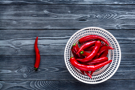 red hot chili pepper frame design on dark wooden table background top view mock-upの写真素材
