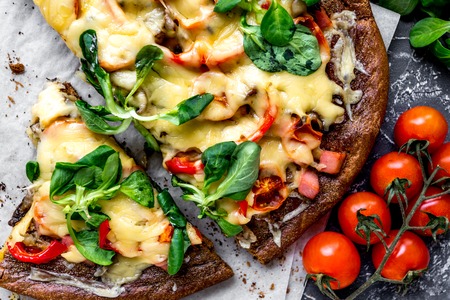 cooking pizza with vegetables and cheese on stone desk background top viewの写真素材