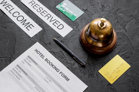 booking form for hotel room reservation, pen and ring dark backgroundの写真素材