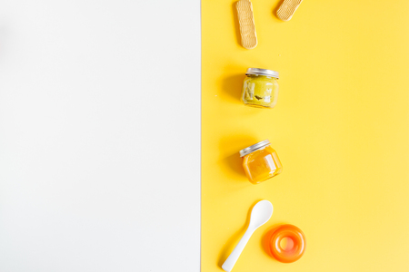 kid stylish set with toys and food white and yellow colored background top view mock-upの写真素材