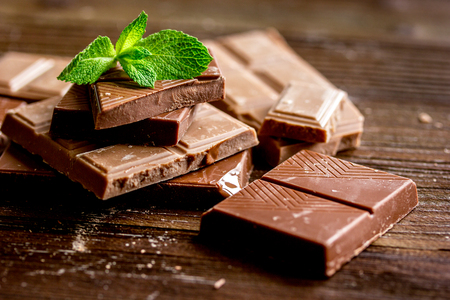 chopped chocolate pieces with mint for dessert on wooden desk backgroundの写真素材