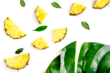 summer dessert with pineapples and leaves on white background top view patternの写真素材
