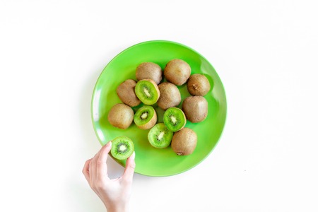 fresh green fruits with kiwi on on plate white background top viewの写真素材