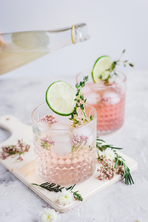 natural nonalcoholic cocktail with herbs and cut lime on stone desk backgroundの写真素材