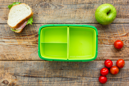 healthy food in lunchbox for dinner at school on wooden table background top viewの写真素材