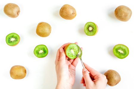 Fresh sliced kiwi for healthy fruit dessert on white table background top view patternの写真素材