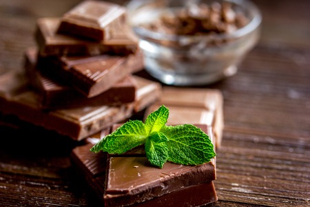 chopped chocolate pieces with mint for dessert wooden desk backgroundの写真素材