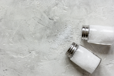 salt in glass bottle on gray table background top view space for textの写真素材