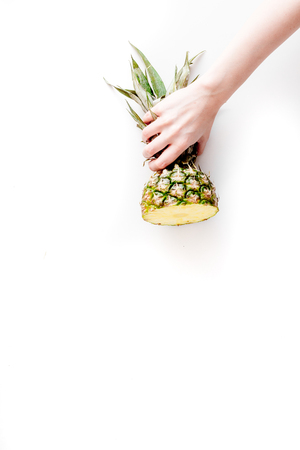 summer dessert with pineapples in hand on white background top view mock upの写真素材
