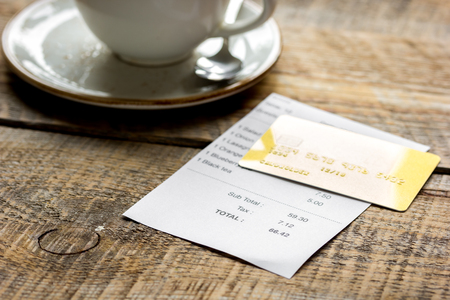 paying check for lunch with card wooden table backgroundの写真素材