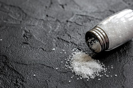 Spices set with salt in glass bottles for cooking on stone kitchen table background mockupの写真素材