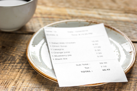 restaurant bill paying by credit card for cup of coffee on wooden table backgroundの写真素材