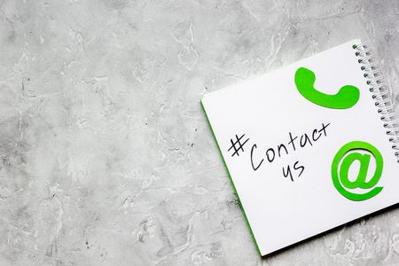 e-mail contact us concept with internet icons on stone work desk background top view mockupの写真素材