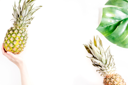 tropical fruits in hand for summer design on white table background top view mock-up