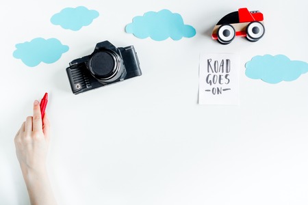 tourist equipment with toys and photo camera for traveling with kids on white background top view mock upの写真素材