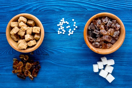lumps of sugar with bowls sweet set on blue kitchen table background top viewの写真素材
