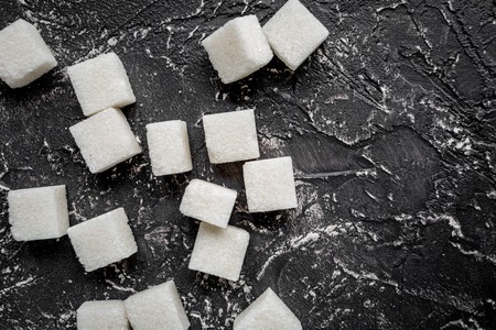 Lumps of sugar sweet set on dark kitchen table background top view mockupの写真素材