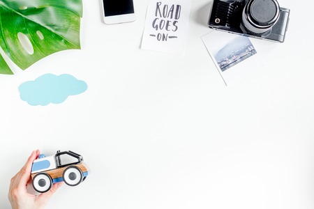 tourist equipment with toys and camera for traveling with kids on white background top view mock up