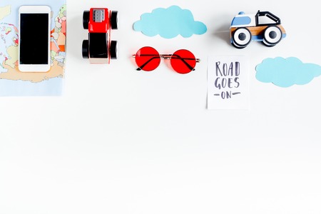 Tourist outfit and mobile for trip with kids on white background top view mock-upの写真素材