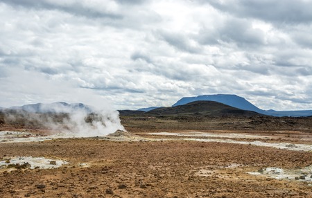 Mudpot in the Namafjall geothermal area, Iceland - area around boiling mud is multicolored and crackedの写真素材