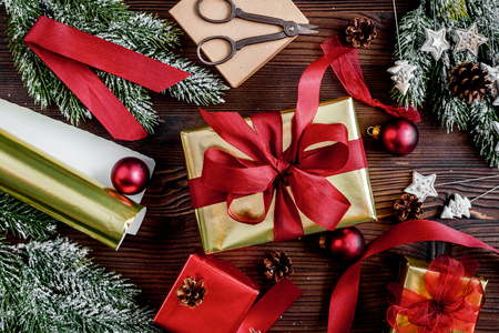 gifts boxes with fir branches on wooden background top viewの写真素材