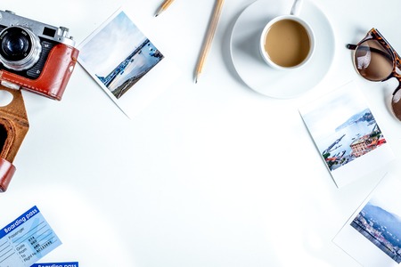 vacation concept with traveller outfit camera and coffee on white desk background top view space for textの写真素材