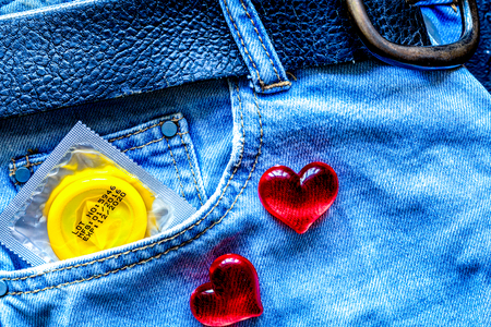 concept male contraception condom in jeans pocket top view.の写真素材