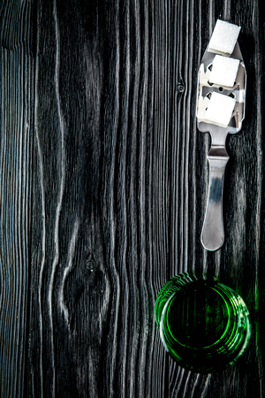 absinthe in glass on wooden background top view mock up